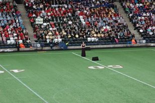 Soprano Zoe Curlett sings in stadium